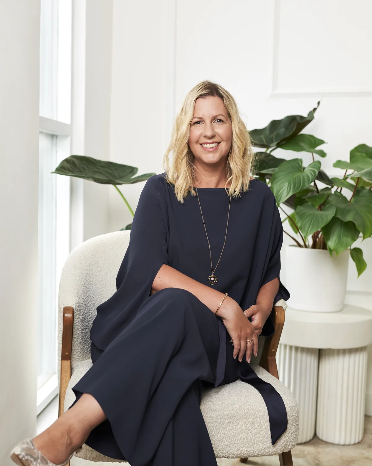 Jo Harris, founder of Business of Beauty, seated in a bright room