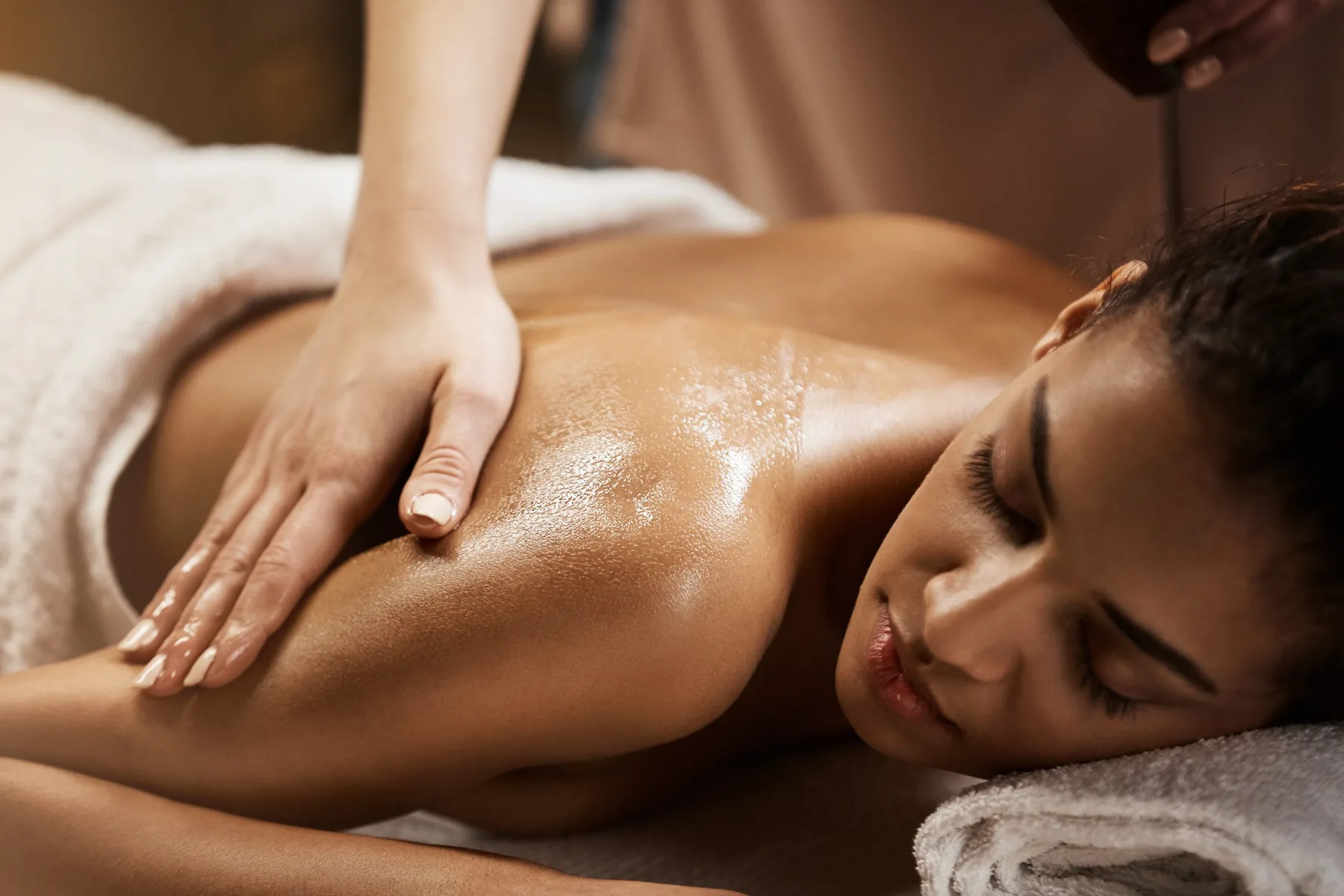 A client receiving a relaxing massage treatment in a spa